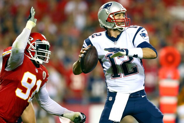 KANSAS CITY, MO - SEPTEMBER 29:  Tamba Hali #91 of the Kansas City Chiefs knocks the ball loose from Tom Brady #12 of the New England Patriots for a fumble during the third quarter at Arrowhead Stadium on September 29, 2014 in Kansas City, Missouri.  (Photo by Dilip Vishwanat/Getty Images)