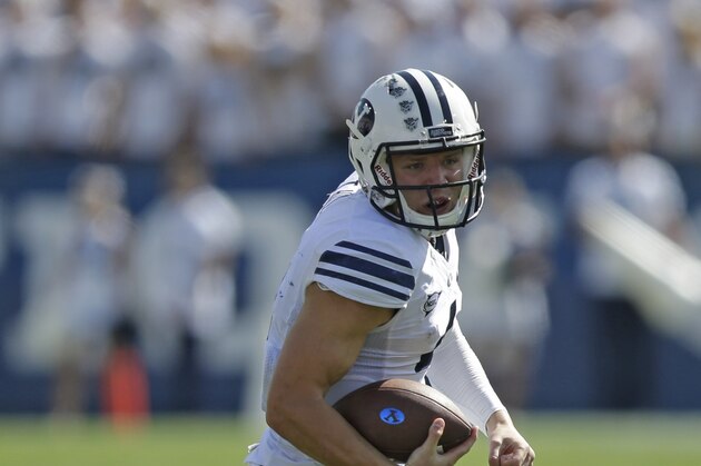 Brigham Young quarterback Taysom Hill (4) carries the ball in the second quarter during an NCAA college football game against Virginia Saturday, Sept. 20, 2014, in Provo, Utah. (AP Photo/Rick Bowmer)