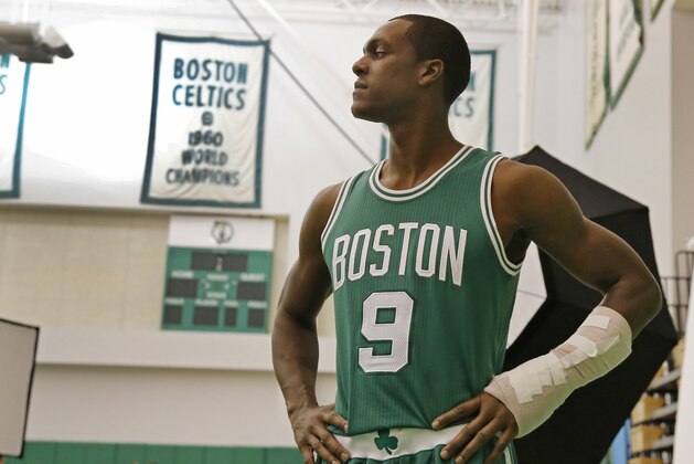 Boston Celtics guard Rajon Rondo poses with his broken hand in a cast for the team photographer during NBA basketball media day in Waltham, Mass., Monday, Sept. 29, 2014. (AP Photo/Elise Amendola)