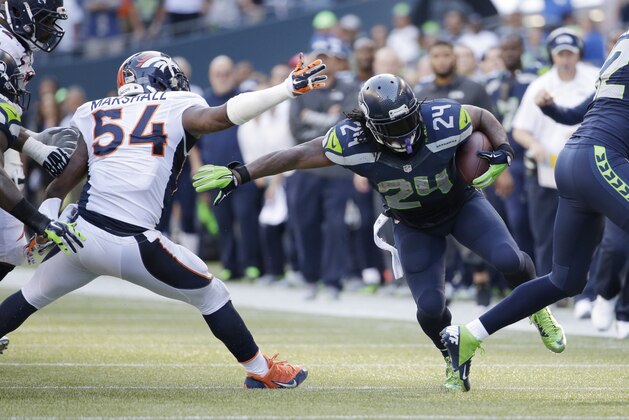 Seattle Seahawks running back Marshawn Lynch (24) runs with the ball in the second half of an NFL football game, Sunday, Sept. 21, 2014, in Seattle. (AP Photo/Elaine Thompson)