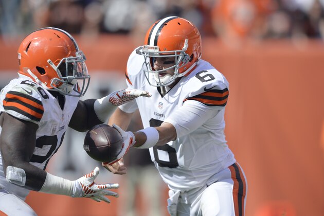 Cleveland Browns quarterback Brian Hoyer (6) hands the ball off to running back Terrance West (28) during an NFL football game against the Baltimore Ravens Sunday, Sept. 21, 2014, in Cleveland. Baltimore won 23-21. (AP Photo/David Richard)