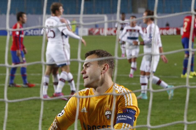 Bayern players, rear, celebrate scoring as CSKA's goalkeeper Igor Akinfeev gets up after failing to stop a penalty during the Group E Champions League match between CSKA Moscow and Bayern Munich at Arena Khimki stadium in Moscow, Russia, Tuesday Sept. 30, 2014. (AP Photo/Pavel Golovkin)