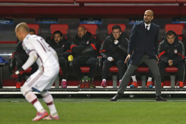Bayern's head coach Pep Guardiola, right, watches his players with Dutch Arjen Robben, left, during the Group E Champions League match between CSKA Moscow and Bayern Munich at Arena Khimki stadium in Moscow, Russia, Tuesday Sept. 30, 2014. (AP Photo/Pavel Golovkin)