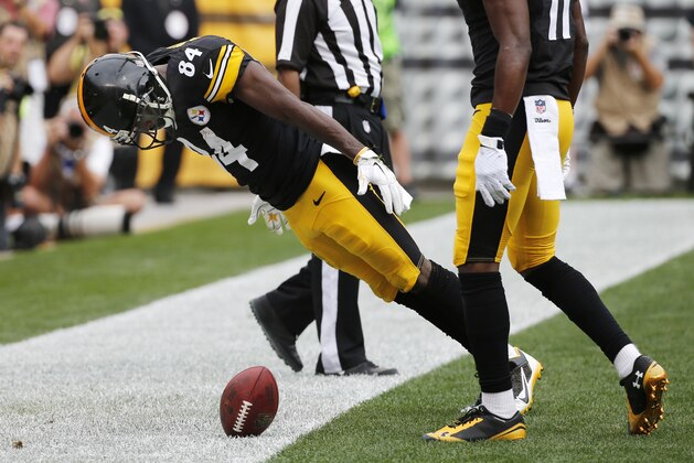 Pittsburgh Steelers wide receiver Antonio Brown (84) falls over the ball after setting it spinning in celebration of making a touchdown catch against the Tampa Bay Buccaneers in the second quarter of the NFL football game on Sunday, Sept. 28, 2014 in Pittsburgh. Brown was penalized for unsportsmanlike conduct. (AP Photo/Gene J. Puskar)