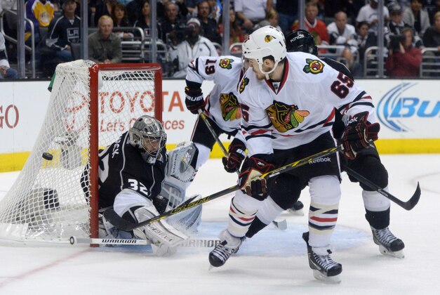 May 26, 2014; Los Angeles, CA, USA; Los Angeles Kings goalie Jonathan Quick (32) deflects a shot by Chicago Blackhawks center Andrew Shaw (65) in the third period in game four of the Western Conference Final of the 2014 Stanley Cup Playoffs at Staples Center. The Kings defeated the Blackhawks 5-2 to take a 3-1 series lead. Mandatory Credit: Kirby Lee-USA TODAY Sports