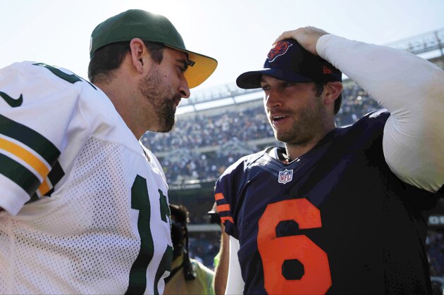 Green Bay Packers quarterback Aaron Rodgers (12) talks to Chicago Bears quarterback Jay Cutler (6) after their NFL football game Sunday, Sept. 28, 2014, in Chicago. The Packers won 38-17. (AP Photo/Charles Rex Arbogast)