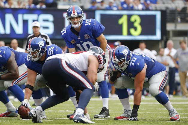 New York Giants quarterback Eli Manning (10) waits for the snap against the Houston Texans in the third quarer of an NFL football game, Sunday, Sept. 21, 2014, in East Rutherford, N.J. (AP Photo/Kathy Willens)