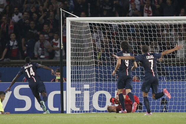 PSG's Blaise Matuidi, second left, celebrates after scoring his side's third goal during the Champions League soccer match between PSG and Barcelona, at the Parc des Princes stadium, in Paris, Tuesday, Sept. 30, 2014. (AP Photo/Christophe Ena)