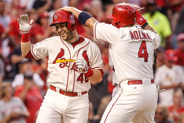 St. Louis Cardinals' Yadier Molina, right, congratulates teammate Tony Cruz, left, on his three-run home run during the second inning of a baseball game against the Cincinnati Reds, Saturday, Sept. 20, 2014, in St. Louis. (AP Photo/Sarah Conard)