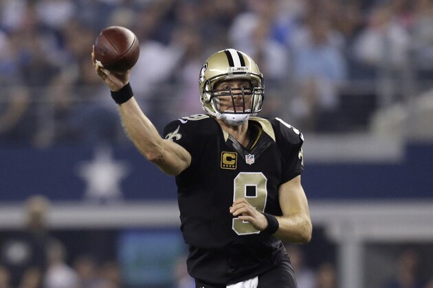 New Orleans Saints quarterback Drew Brees (9) passes during the first half of an NFL football game against the Dallas Cowboys, Sunday, Sept. 28, 2014, in Arlington, Texas. (AP Photo/Tim Sharp)