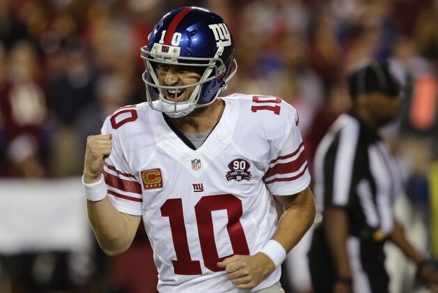 New York Giants quarterback Eli Manning (10) reacts to this third touchdown pass to tight end Larry Donnell during the first half of an NFL Thursday night football game against the Washington Redskins in Landover, Md., Thursday, Sept. 25, 2014. (AP Photo/Mark Tenally)