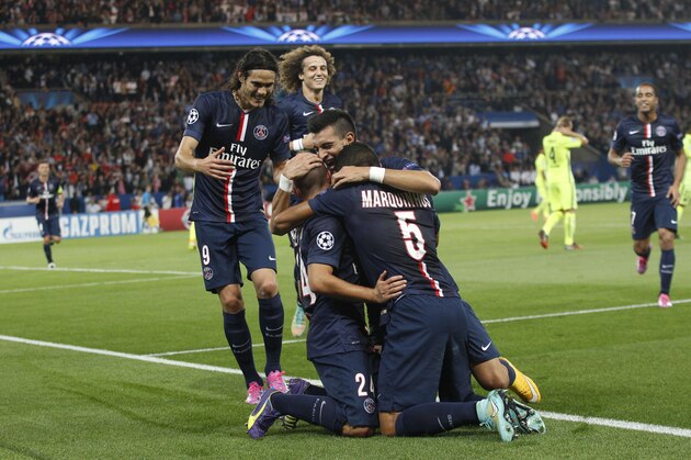 PSG players celebrate after Marco Verratti scored his side's second goal during the Champions League soccer match between PSG and Barcelona, at the Parc des Princes stadium, in Paris, Tuesday, Sept. 30, 2014. (AP Photo/Christophe Ena)