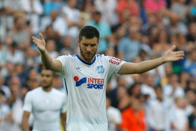 Marseille's French forward Andre-Pierre Gignac  gestures to supporters at the end of their League One soccer match against Rennes, at the Velodrome Stadium, in Marseille, southern France, Saturday, Sept. 20, 2014. (AP Photo/Claude Paris)