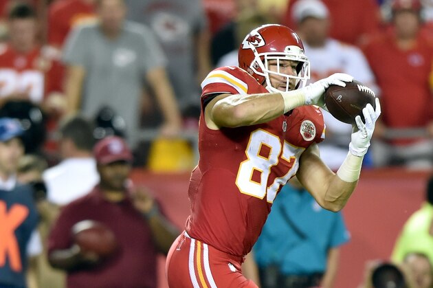 KANSAS CITY, MO - SEPTEMBER 29:  Travis Kelce #87 of the Kansas City Chiefs completes a pass against the New England Patriots  at Arrowhead Stadium on September 29, 2014 in Kansas City, Missouri.  (Photo by Peter Aiken/Getty Images)