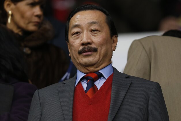 Cardiff City's owner Vincent Tan looks on from the stand before the start of their English Premier League soccer match against Tottenham Hotspur at White Hart Lane, London, Sunday, March 2, 2014. (AP Photo/Sang Tan)