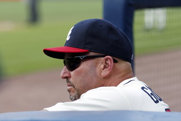 Atlanta Braves manager Fredi Gonzalez (33) watch from the dugout during a baseball game against the Arizona Diamondbacks in Atlanta, Saturday, July 5, 2014.  (AP Photo/John Bazemore)
