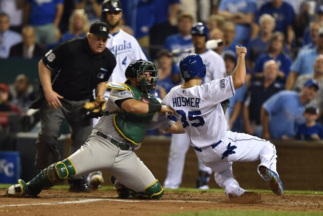 Sep 30, 2014; Kansas City, MO, USA; Kansas City Royals first baseman Eric Hosmer (35) is tagged out at first base by Oakland Athletics catcher Geovany Soto (17) to end the first inning in the 2014 American League Wild Card playoff baseball game at Kauffman Stadium. Mandatory Credit: Peter G. Aiken-USA TODAY Sports