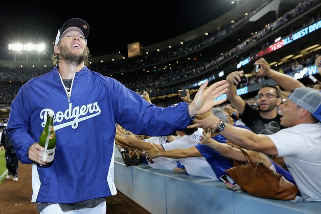 LOS ANGELES, CA - SEPTEMBER 24: Clayton Kershaw #22 of the Los Angeles Dodgers celebrates with fans following the Dodgers' 9-1 victory over the San Francisco Giants to win the National League West Division Championship at Dodger Stadium on September 24, 2014 in Los Angeles, California. (Photo by Jeff Gross/Getty Images) LOS ANGELES, CA - SEPTEMBER 24: Clayton Kershaw #22 of the Los Angeles Dodgers celebrates with fans following the Dodgers' 9-1 victory over the San Francisco Giants to win the National League West Division Championship at Dodger Stadium on September 24, 2014 in Los Angeles, California. (Photo by Jeff Gross/Getty Images)