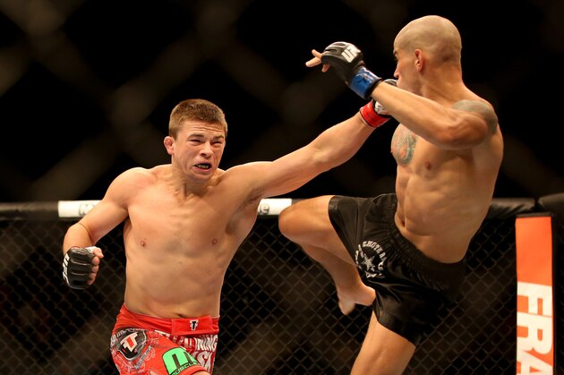 Jul 16, 2014; Atlantic City, NJ, USA; Rick Story (red gloves) lunges with a punch while Leonardo Mafra (blue gloves) gets a leg up during a welterweight bout at Revel Casino. Mandatory Credit: Bill Streicher-USA TODAY Sports