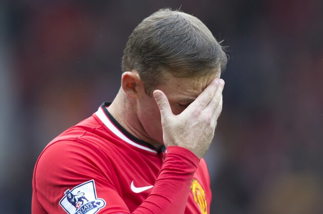 Manchester United's Wayne Rooney takes to the pitch before his team's English Premier League soccer match against West Ham United at Old Trafford Stadium, Manchester, England, Saturday Sept. 27, 2014. (AP Photo/Jon Super)