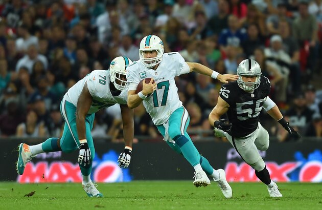 Miami Dolphins' Ryan Tannehill runs with the ball during the NFL football game against Oakland Raiders at Wembley Stadium in London, Sunday, Sept. 28, 2014. (AP Photo/Tim Ireland)