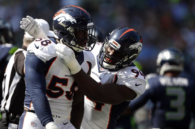 SEATTLE, WA - SEPTEMBER 21: Outside linebacker Von Miller #58 of the Denver Broncos celebrates with defensive end DeMarcus Ware #94 of the Denver Bronco after making a play during the second quarter of the game against the Seattle Seahawks at CenturyLink Field on September 21, 2014 in Seattle, Washington. (Photo by Otto Greule Jr/Getty Images)