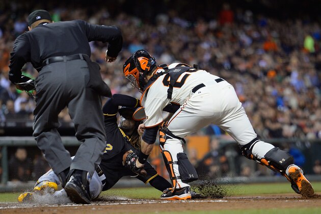 SAN FRANCISCO, CA - AUGUST 22:  Andrew McCutchen #22 of the Pittsburgh Pirates is tagged out at home plate by Buster Posey #28 of the San Francisco Giants in the third inning at AT&T Park on August 22, 2013 in San Francisco, California. McCutchen was attempting to score from third on a ground ball hit back to the pitcher.  (Photo by Thearon W. Henderson/Getty Images)