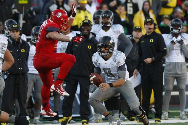 Oregon quarterback Marcus Mariota (8) during the first half of an NCAA football game against Arizona, Saturday, Nov. 23, 2013, in Tucson, Ariz. (AP Photo/Rick Scuteri)