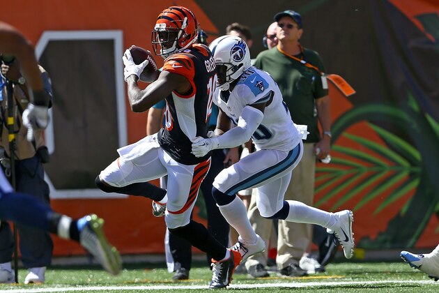 CINCINNATI, OH - SEPTEMBER 21:  Jason McCourty #30 of the Tennessee Titans tackles A.J. Green #18 of the Cincinnati Bengals during the first quarter at Paul Brown Stadium on September 21, 2014 in Cincinnati, Ohio. (Photo by Andy Lyons/Getty Images)
