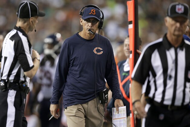 Chicago Bears coach Marc Trestman, center, looks toward an official in the first half of a preseason NFL football game against the Seattle Seahawks, Friday, Aug. 22, 2014, in Seattle. (AP Photo/Stephen Brashear)