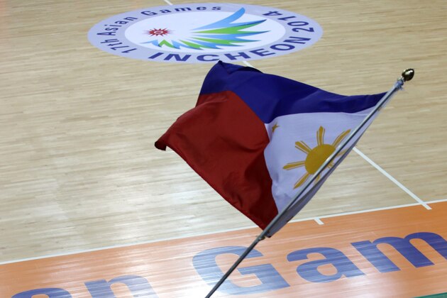 INCHEON, SOUTH KOREA - SEPTEMBER 25:  A Philippines supporter waves a flag during the Basketball Mens Preliminary round match between Iran and the Philippines during day five of the 2014 Asian Games at Hwaseong Sports Complex Gymnasium on September 25, 2014 in Incheon, South Korea.  (Photo by Stanley Chou/Getty Images)