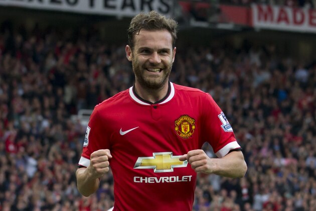 Manchester United's Juan Mata celebrates after scoring against Queens Park Rangers during their English Premier League soccer match at Old Trafford Stadium, Manchester, England, Sunday Sept. 14, 2014. (AP Photo/Jon Super)