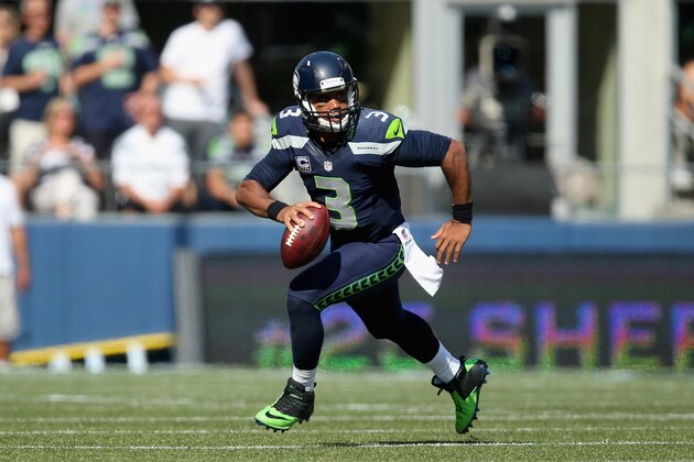 SEATTLE, WA - SEPTEMBER 21:  Quarterback Russell Wilson #3 of the Seattle Seahawks runs with the ball against the Denver Broncos at CenturyLink Field on September 21, 2014 in Seattle, Washington.  (Photo by Jeff Gross/Getty Images)