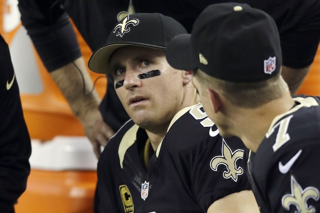 New Orleans Saints quarterback Drew Brees (9) watches action against the Dallas Cowboys from the sideline bench during the first half of an NFL football game Sunday, Sept. 28,2014, in Arlington, Texas. (AP Photo/Tim Sharp)