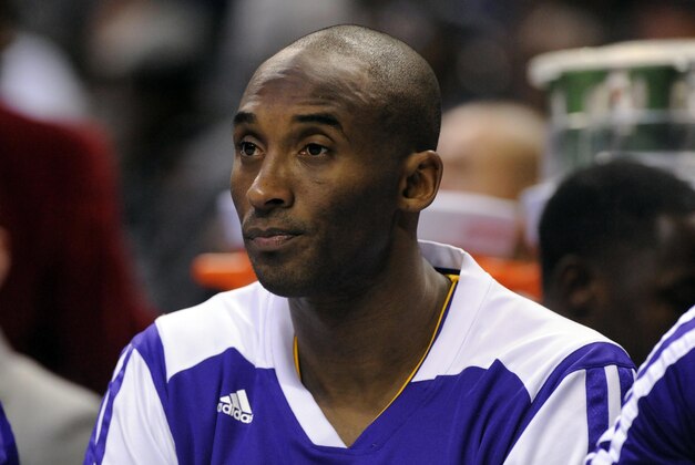 Dec 14, 2013; Charlotte, NC, USA; Los Angeles Lakers guard Kobe Bryant (24) watches his team from the bench during the first half of the game against the Los Angeles Lakers at Time Warner Cable Arena. Mandatory Credit: Sam Sharpe-USA TODAY Sports