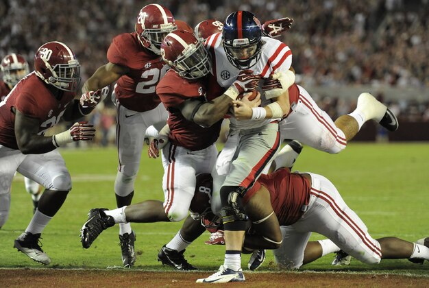 Sep 28, 2013; Tuscaloosa, AL, USA; Mississippi Rebels quarterback Bo Wallace (14) is sacked in the end zone for a safety by Alabama Crimson Tide linebacker C.J. Mosley (32) , defensive lineman Jeoffrey Pagan (8) , defensive lineman Brandon Ivory (99) , defensive back Jarrick Williams (20) and linebacker Denzel Devall (30) during the fourth quarter at Bryant-Denny Stadium. The Alabama Crimson Tide defeated the Mississippi Rebels 25-0. Mandatory Credit: John David Mercer-USA TODAY Sports