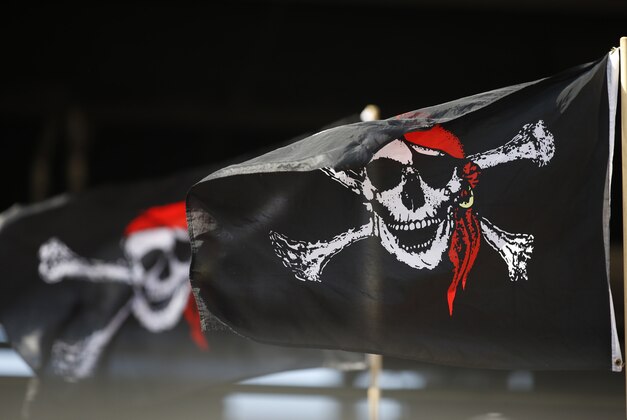Sep 21, 2014; Pittsburgh, PA, USA; Pittsburgh Pirates fans fly Jolly Roger flags as the Pirates host the Milwaukee Brewers during the ninth inning at PNC Park. The Pirates won 1-0. Mandatory Credit: Charles LeClaire-USA TODAY Sports
