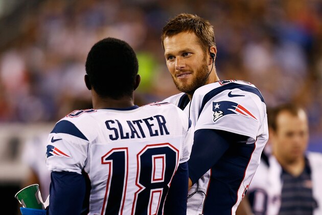 EAST RUTHERFORD, NJ - AUGUST 28:  Tom Brady #12 of the New England Patriots chats with teammate Matthew Slater #18 during the preseason game against the New York Giants at MetLife Stadium on August 28, 2014 in East Rutherford, New Jersey.  (Photo by Jeff Zelevansky/Getty Images)