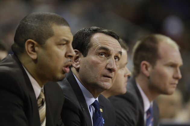 Duke head coach Mike Krzyzewski, center, looks up at the game clock during the first half of their NCAA mens college basketball game against the Boston College on Boston College campus in Boston, Saturday, Feb. 8, 2014. Duke defeated Boston College 89-68. (AP Photo/Stephan Savoia)