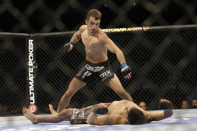 Myles Jury, top, prepares to punch Ramsey Nijem during the second round of a UFC lightweight mixed martial arts fight in San Jose, Calif., Saturday, April 20, 2013. Jury won by knock out in the second round. (AP Photo/Jeff Chiu)