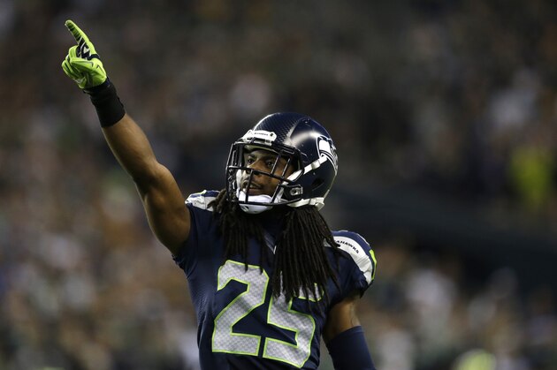 Seattle Seahawks cornerback Richard Sherman points to the crowd in the second half of an NFL football game between the Seattle Seahawks and the Green Bay Packers, Thursday, Sept. 4, 2014, in Seattle. (AP Photo/Scott Eklund)