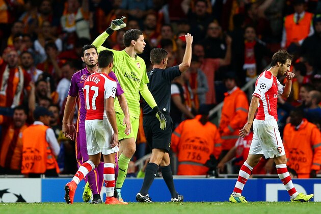 LONDON, ENGLAND - OCTOBER 01:  Wojciech Szczesny of Arsenal receives a red card from referee Gianluca Rocchi during the UEFA Champions League group D match between Arsenal FC and Galatasaray AS at Emirates Stadium on October 1, 2014 in London, United Kingdom.  (Photo by Paul Gilham/Getty Images)