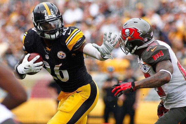 PITTSBURGH, PA - SEPTEMBER 28:  Le'Veon Bell #26 of the Pittsburgh Steelers carries the ball in front of Leonard Johnson #29 of the Tampa Bay Buccaneers during the second quarter at Heinz Field on September 28, 2014 in Pittsburgh, Pennsylvania.  (Photo by Justin K. Aller/Getty Images)