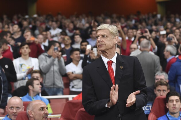 Arsenal's coach Arsene Wenger claps his hands during the Champions League Group D soccer match between Arsenal  and Galatasaray , at the Emirates Stadium in London, on Wednesday, Oct 1, 2014. (AP Photo/ Tim Ireland)
