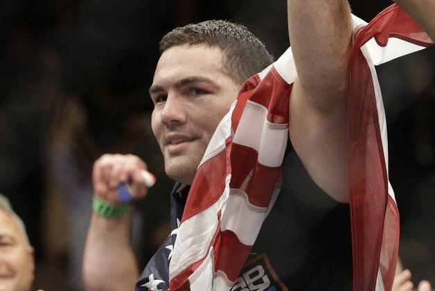 Chris Weidman celebrates after defeating Lyoto Machida, right, in their mixed martial arts middleweight title bout at UFC 175 Saturday, July 5, 2014, in Las Vegas. (AP Photo/John Locher)