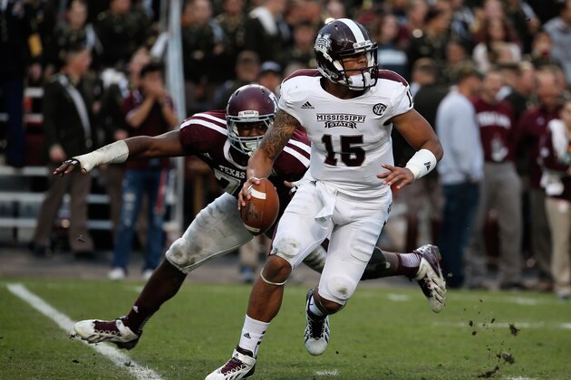 COLLEGE STATION, TX - NOVEMBER 09:  Dak Prescott #15 of the Mississippi State Bulldogs looks to pass against the Texas A&M Aggies at Kyle Field on November 9, 2013 in College Station, Texas.  (Photo by Scott Halleran/Getty Images)