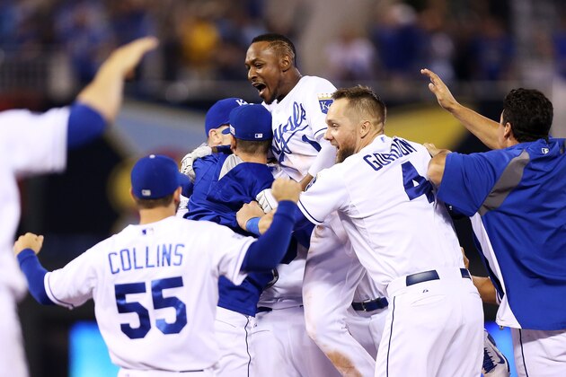 KANSAS CITY, MO - SEPTEMBER 30:  The Kansas City Royals celebrate their 9 to 8 win over the Oakland Athletics in the 12th inning of their American League Wild Card game at Kauffman Stadium on September 30, 2014 in Kansas City, Missouri.  (Photo by Ed Zurga/Getty Images)