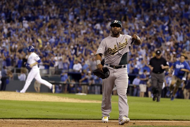 Oakland Athletics' Alberto Callaspo walks off the field after the A's 9-8 loss to the Kansas City Royals in the AL wild-card playoff baseball game Tuesday, Sept. 30, 2014, in Kansas City, Mo. (AP Photo/Jeff Roberson)