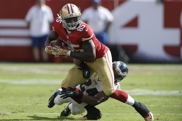 San Francisco 49ers tight end Vernon Davis (85) is tackled by Philadelphia Eagles cornerback Bradley Fletcher (24) during the third quarter of an NFL football game in Santa Clara, Calif., Sunday, Sept. 28, 2014. Davis was injured on the play. (AP Photo/Ben Margot)