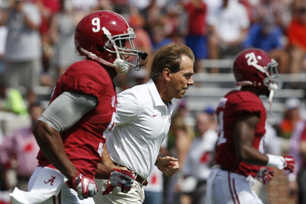 Alabama head coach Nick Saban runs the field next to wide receiver Amari Cooper (9) before an NCAA college football game against Florida, Saturday, Sept. 20, 2014, in Tuscaloosa, Ala. (AP Photo/Brynn Anderson)